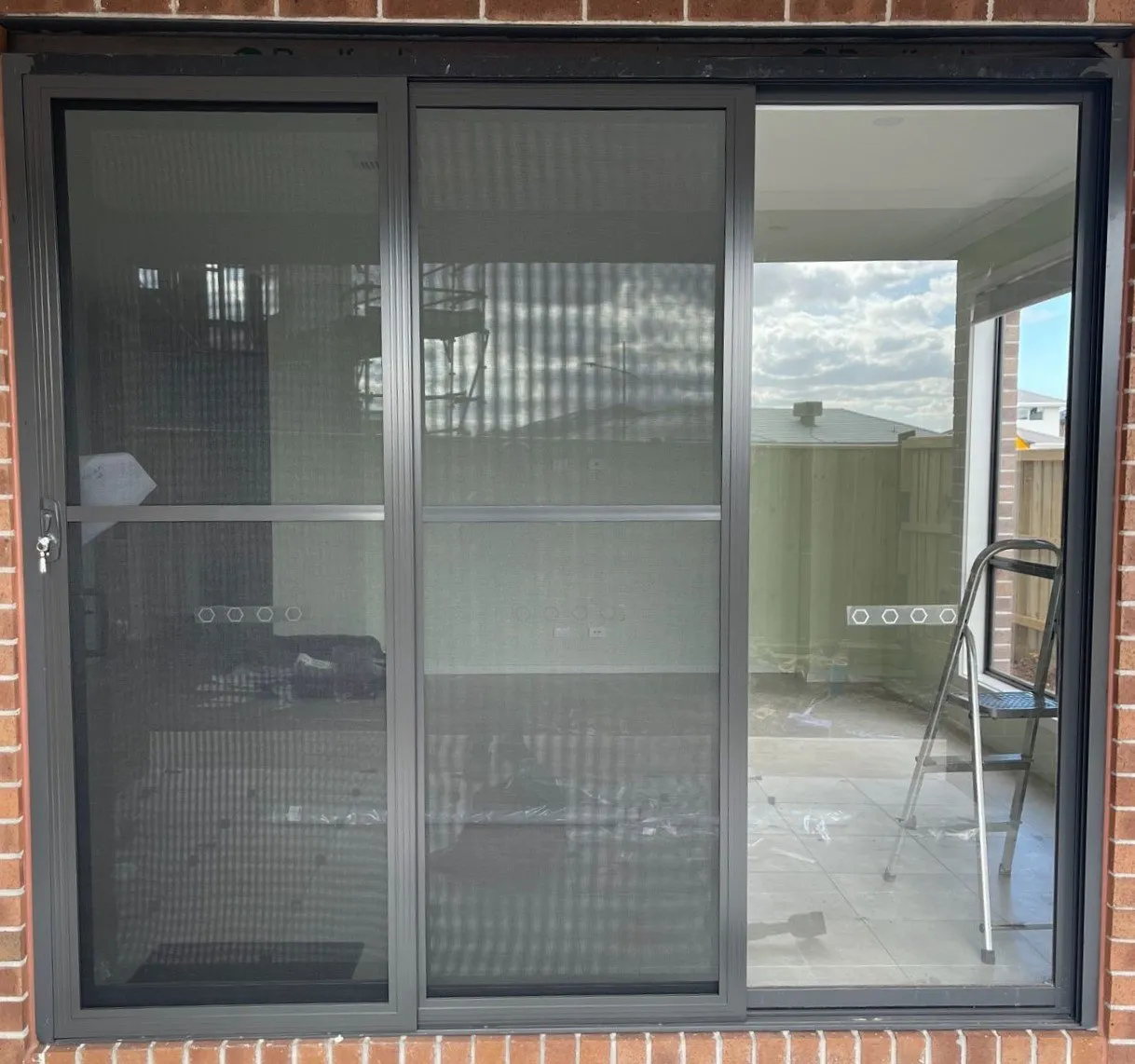 A sliding door screen installed by Galaxy Blinds